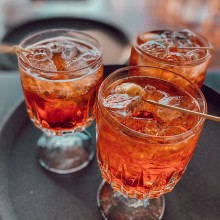 Three Aperol spritzers on a tray